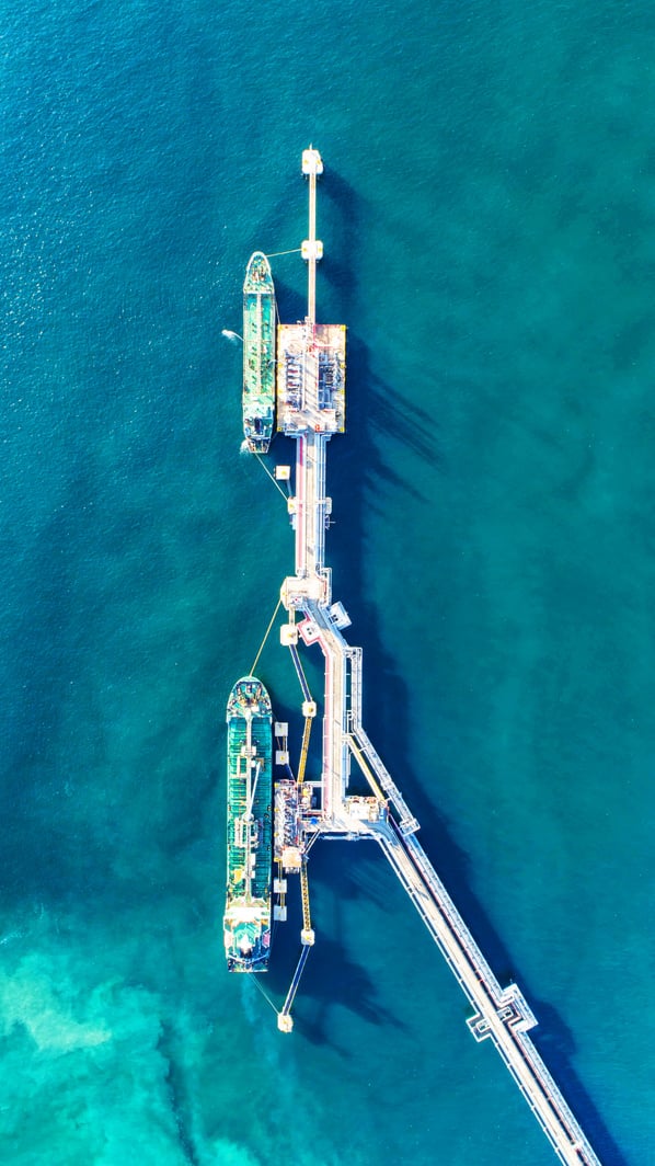 oil tanker, gas tanker in the high sea.Refinery Industry cargo ship,aerial view,Thailand, in import export, LPG,oil refinery, Logistics and transportation with working crane bridge in harbor